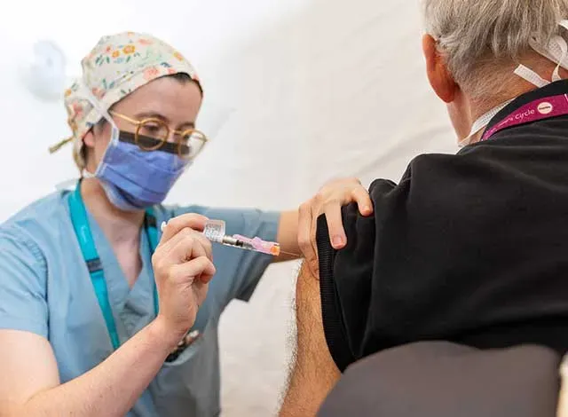 Vaccination Nurse/Doctor administering vaccine to an elderly gentleman.