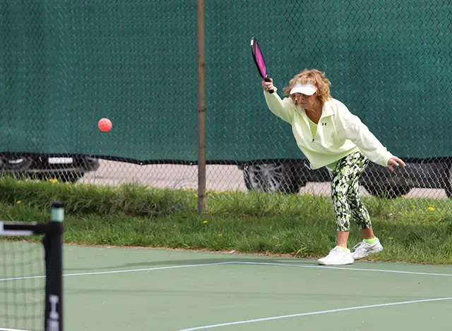 Pickle-Patricia Patricia Lynch serves during a pickleball open house.