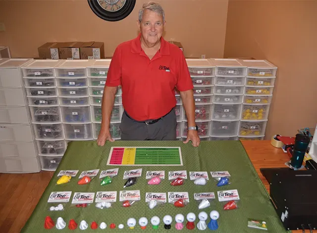 Mario Caya showing his BirTee invention.