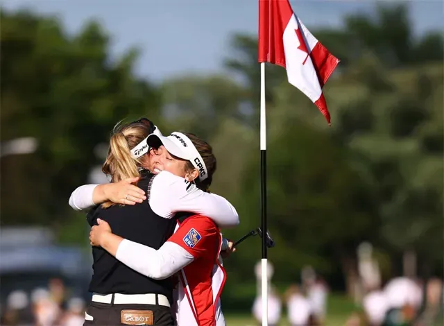Brittany and Brooke Henderson hug