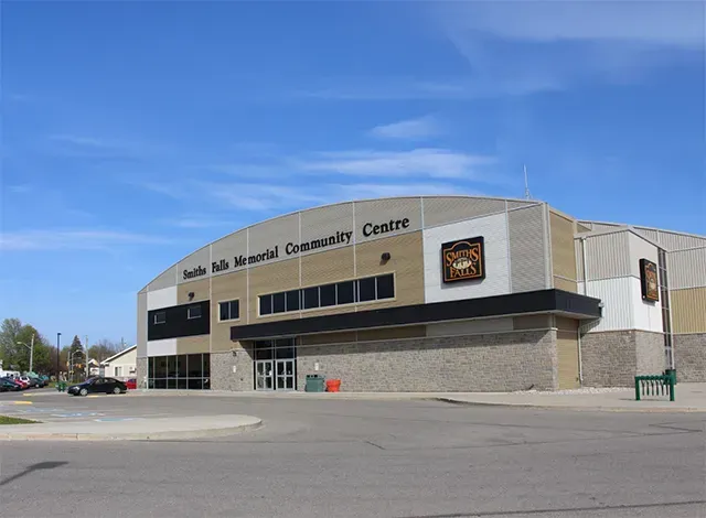 Smiths Falls Memorial Centre Front view of Smiths Falls Memorial Community Centre under blue sky, highlighting arena cost-sharing facilities.