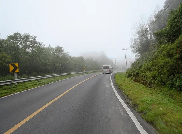 Generic image of a van on a rural road. A visual of what Helping Hands is.