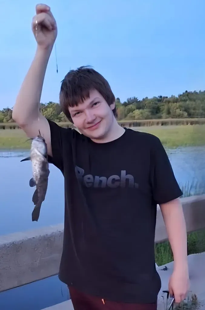 Perth community gathering for Reese Stanzel [Pictured smiling while holding up a catfish on a fishing line].