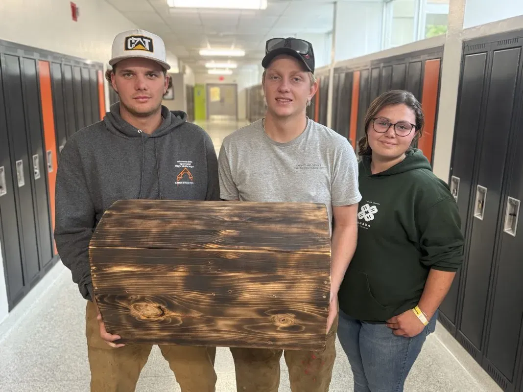 ADHS students holding time capsule.