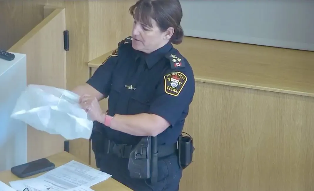 Smiths Falls Police Chief Jodi Empy displays spit hood